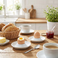 Breakfast scene with bread, coffee, and an egg on a wooden table.