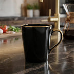 Black mug on a kitchen counter with blurred background