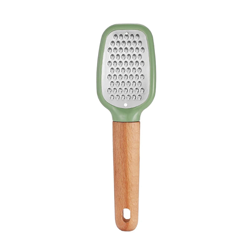 Grater with green top and wooden handle on a white background