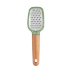 Grater with green top and wooden handle on a white background