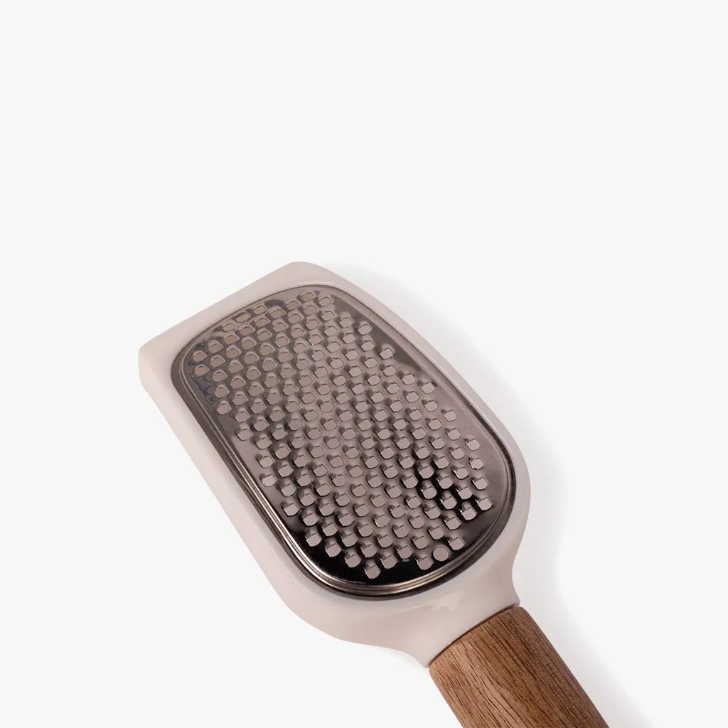 Grooming brush with wooden handle on a white background
