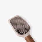 Grooming brush with wooden handle on a white background