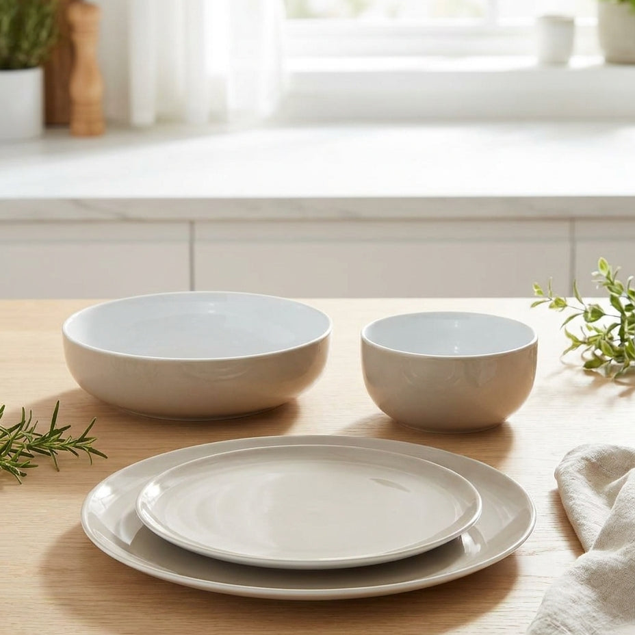 Set of ceramic dishes on a wooden table with a kitchen background