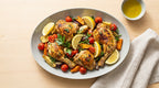 Plated dish of roasted chicken with vegetables on a wooden table