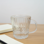 Clear glass mug with handle on a wooden surface